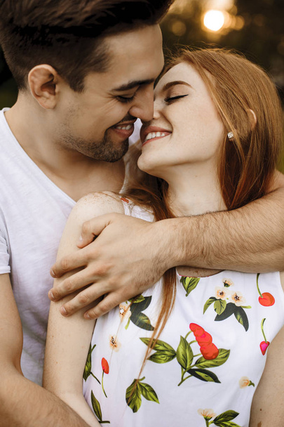Close up portrait of a handsome couple embracing and smiling bef - Photo, Image