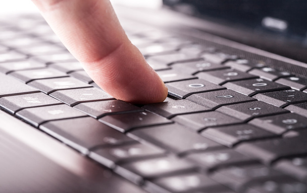 finger on laptop keyboard - Photo, Image