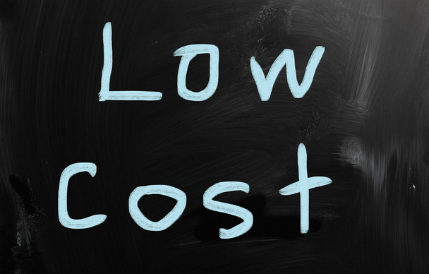 "Low cost" handwritten with white chalk on a blackboard - Photo, Image