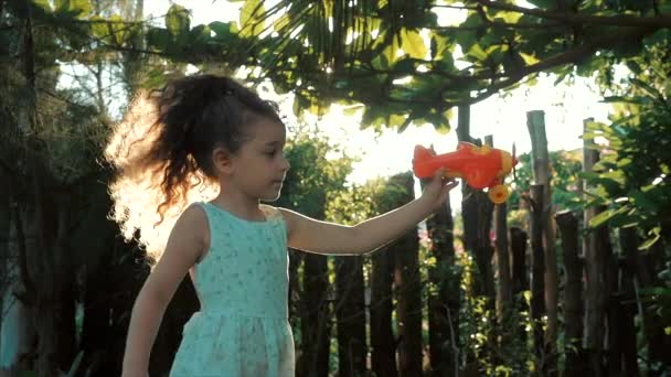 Happy Child Runs With A Toy Airplane On A Sunset Background. - Materiał filmowy, wideo