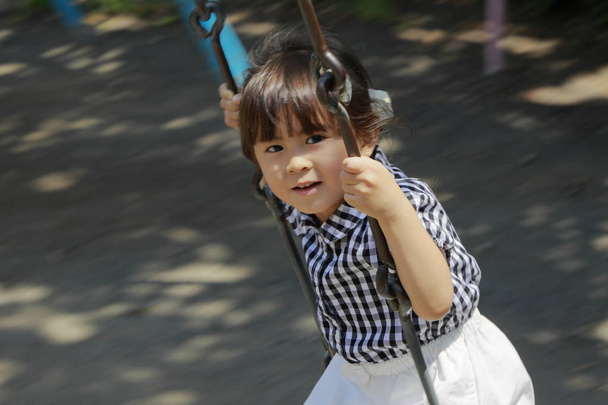 Japanese girl on the swing (4 years old) - Photo, Image