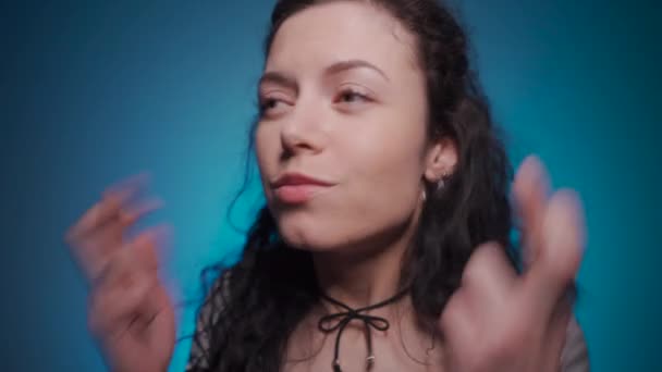 studio shot of curly brunette female praying with hope - Filmati, video