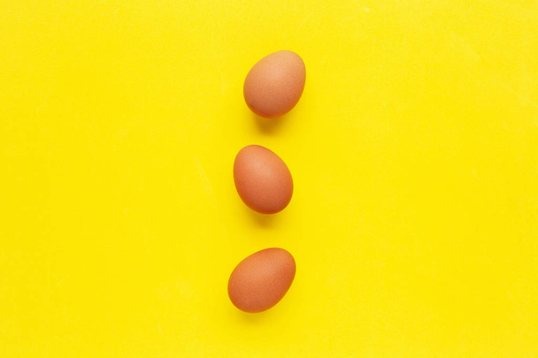 Eggs on yellow background. - Foto, Bild