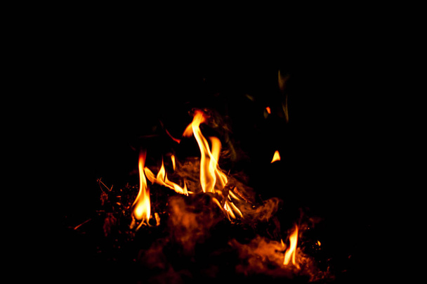 Fire flames on a black background - Foto, afbeelding