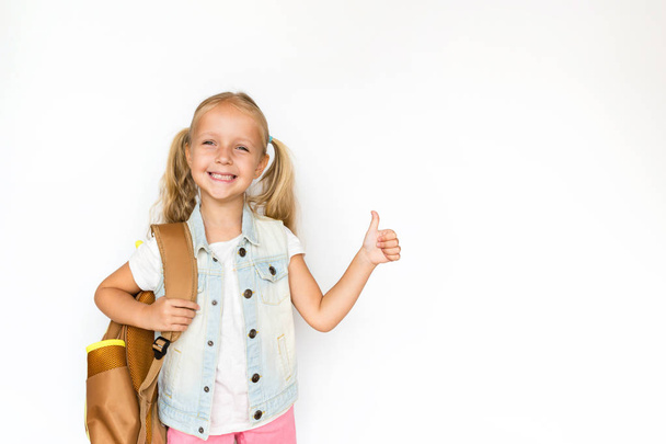 Back to school and happy time. Cute child with blonde hair on white background. Kid with backpack. Girl ready to study. Mockup, place for text, education concept - Valokuva, kuva