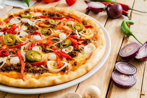 tasty pizza on the wooden background, close up - Photo, Image
