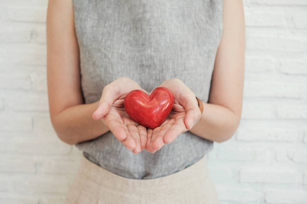 woman holding red heart, health insurance, donation charity conc - Фото, зображення