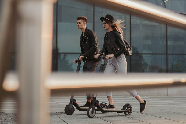 Pareja romántica casual en scooters están montando en la ciudad
 - Foto, imagen