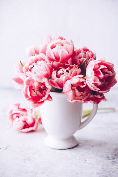 Bouquet of Spring tulips in vase on shabby chic background - 写真・画像