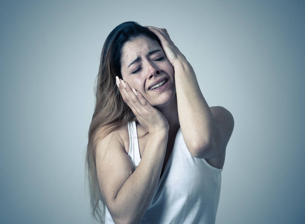 Young woman suffering from depression feeling miserable hopeless and suicidal. Portrait of depressed teen female crying in distress. Facial expressions Human emotions and Mental health concept. - Foto, Imagem