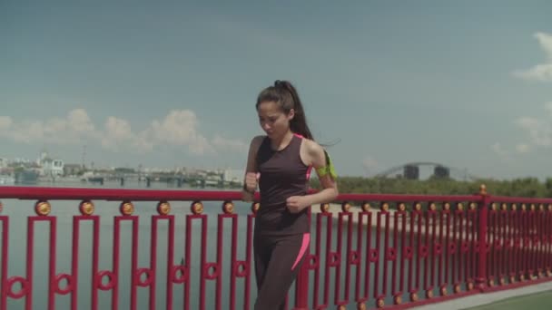 Fit woman jogger running looking at sports watch - Video