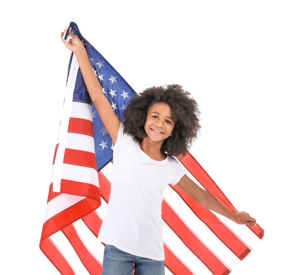 Cute African-American girl with national flag of USA on white background - Photo, Image