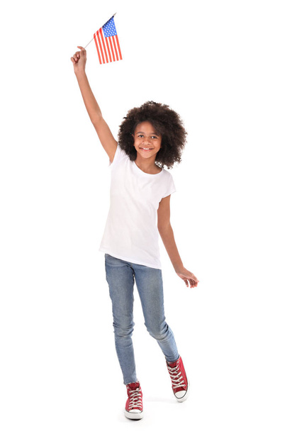 Cute African-American girl with national flag of USA on white background - Fotó, kép