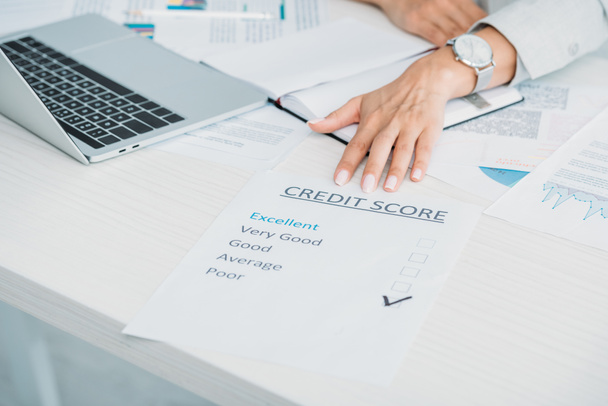 cropped view of woman showing credit score at office  - Photo, Image