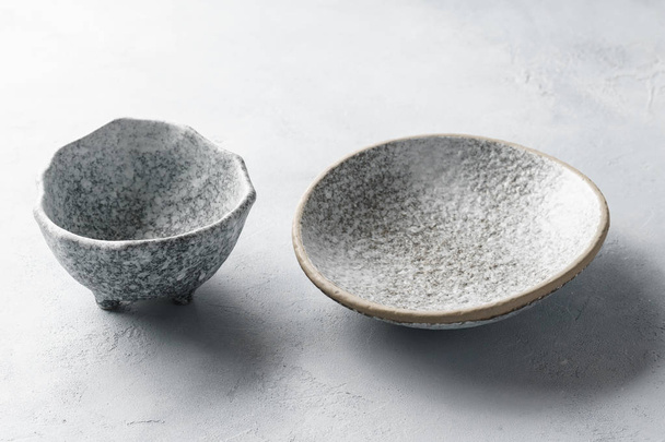 Empty ceramic bowls on concrete gray background. - Foto, afbeelding