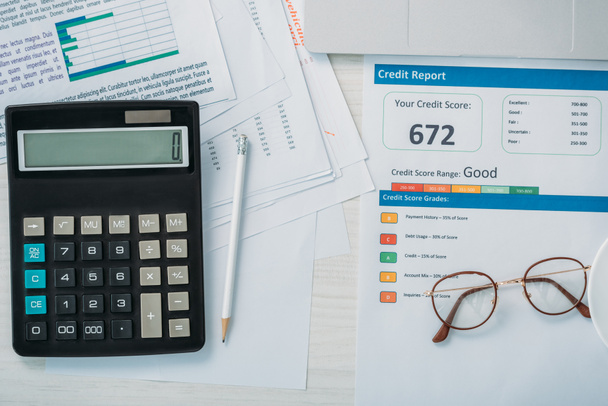 top view of credit report, calculator, glasses and pencil  - Foto, Imagem
