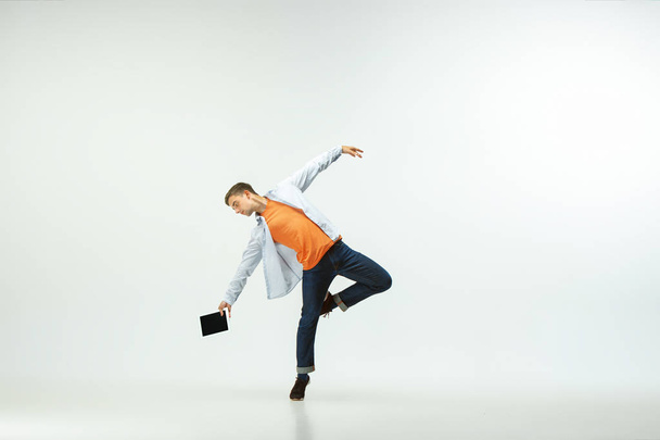 Man working at office and jumping isolated on studio background - Foto, afbeelding