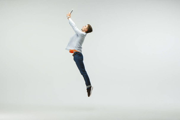 Man working at office and jumping isolated on studio background - Фото, зображення