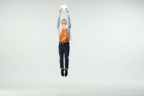 Man working at office and jumping isolated on studio background - Fotó, kép