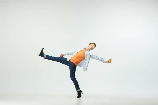 Man working at office and jumping isolated on studio background - Foto, imagen