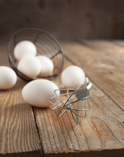 Metal whisk and fresh eggs - Photo, Image