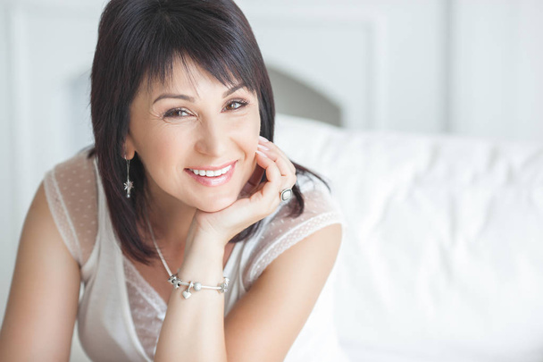 Closeup portrait of beautiful mature woman. Mid adult lady indoors. Smiling woman. Attractive female. - Photo, Image
