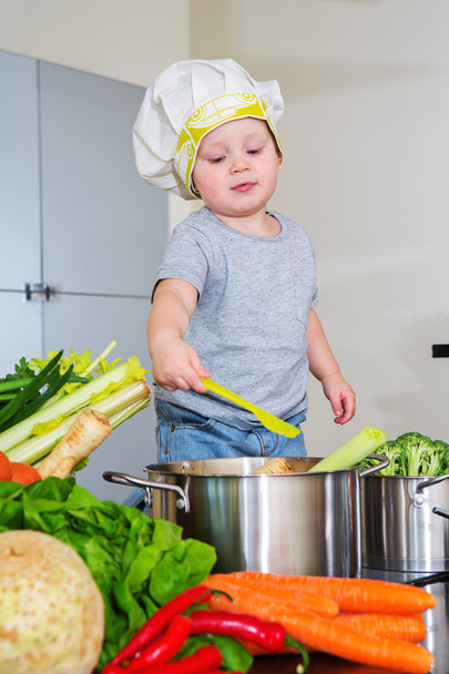 Happy child at kitchen preparing soup - Fotografie, Obrázek
