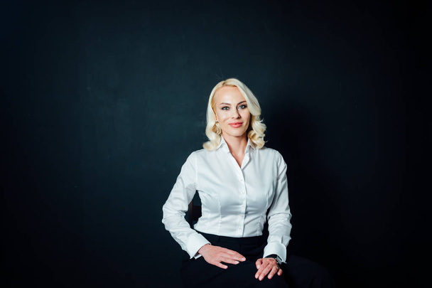 Portrait of a blonde woman in a white shirt - Fotoğraf, Görsel
