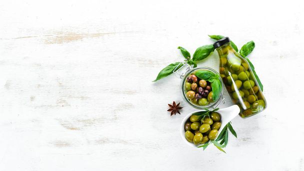A set of olives on a white wooden background. Top view. Free space for your text. - Фото, зображення