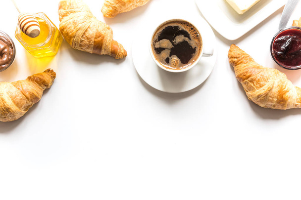 Cup of coffee and freshly baked croissants. Top view. Copy space - Foto, Imagen
