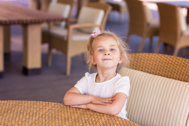 Cute little child at the table in a restaurant - Foto, imagen