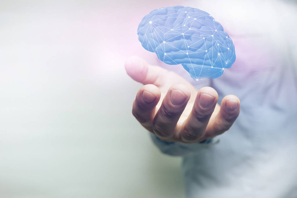 Human holding brain in palm. Mixed media.  - Foto, imagen