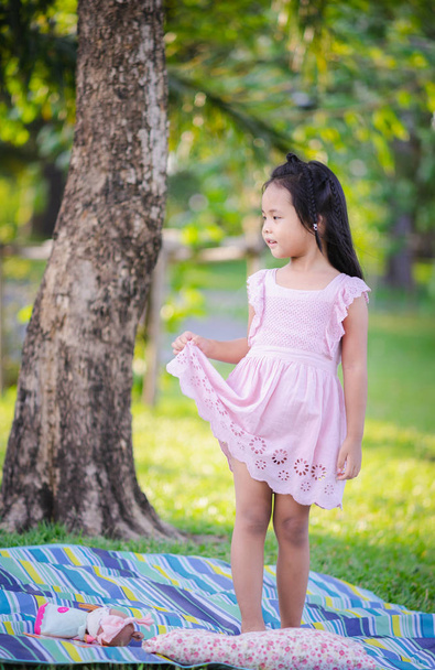 portrait of cute little girl standing in the park - Fotoğraf, Görsel