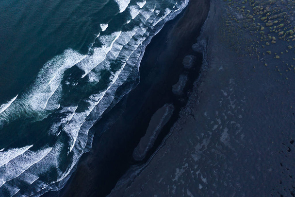 Aerial shot of black stone beach with waves. - Photo, Image