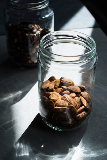 Jar of Organic Raw Almonds with Natural Light Ready to Eat. - Foto, Imagen