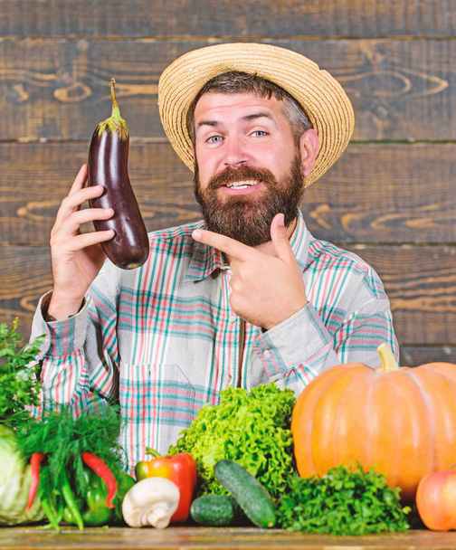 Grow organic crops. Homegrown organic food. Man with beard wooden background. Organic horticulture concept. Farmer with organic vegetables. Gardening and farming systems prescribe specific techniques - Photo, Image