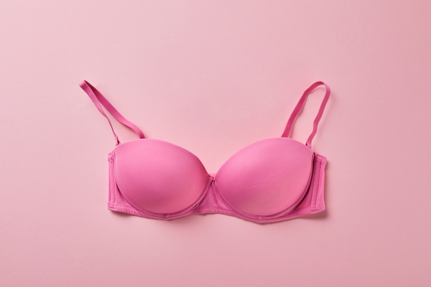 top view of brassiere on pink background, breast cancer concept - 写真・画像