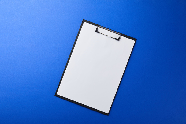 folder with empty paper isolated on blue - Photo, Image