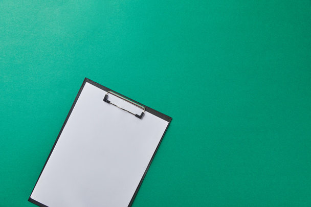 top view of folder with empty paper isolated on green - Photo, Image