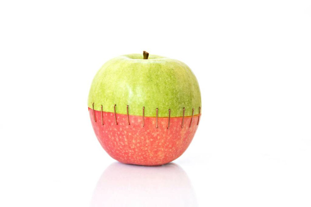 Combine the top of a green apple with the buttom of a red one   - Photo, Image