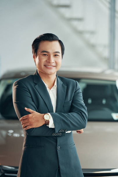 Portrait of happy mature car dealership owner, Asian man looking at camera with smile  - Foto, imagen