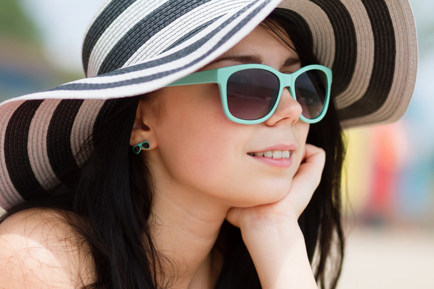 Young brunette in turqoise sunglasses - Fotó, kép