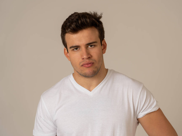 Close up headshot of young latin man with natural and neutral face and masculine look. Isolated on neutral background. In People, fashion, lifestyle Beauty and human emotions concept. - Φωτογραφία, εικόνα