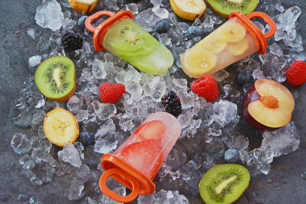 gelo de frutas com pedaços de frutas em cubos de gelo
  - Foto, Imagem