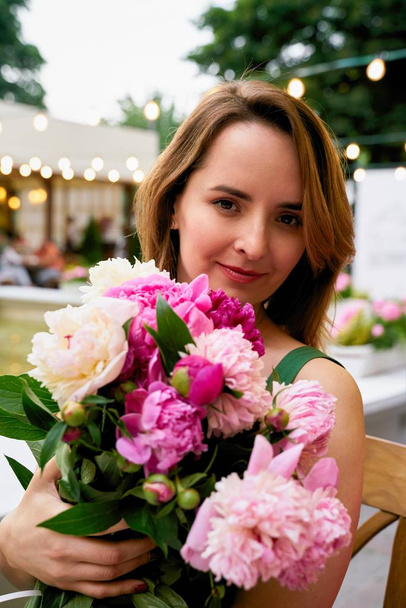 Beautiful young woman with bouquet of fresh peonies  - Fotoğraf, Görsel