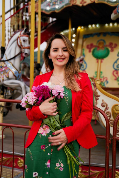 Beautiful young woman with bouquet of fresh peonies  - Fotografie, Obrázek