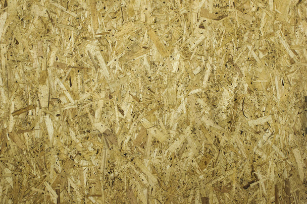 OSB tahtaları ahşap bir arka plana zımparalanmış kahverengi odun parçalarından yapılmıştır. - Fotoğraf, Görsel