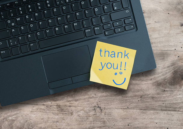 thank you written on sticky note on laptop computer - Photo, Image