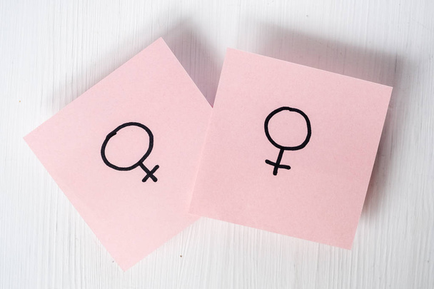 Two pink stickers with gender symbols Venus on white background. Concept lgbt. - Фото, изображение