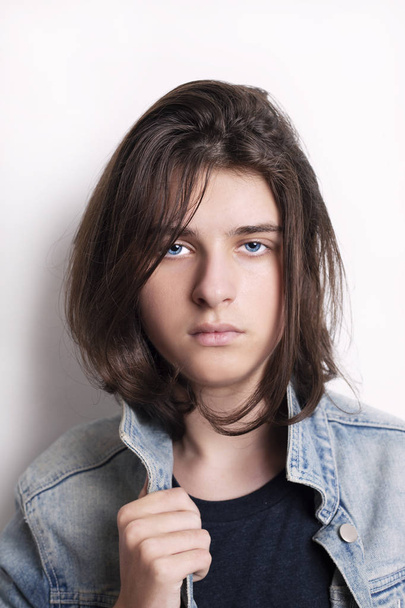 Portrait of a teenager with jeans jacket in studio. - Фото, изображение